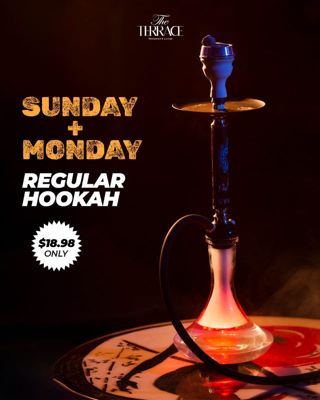 A regular hookah glowing red on a patterned table